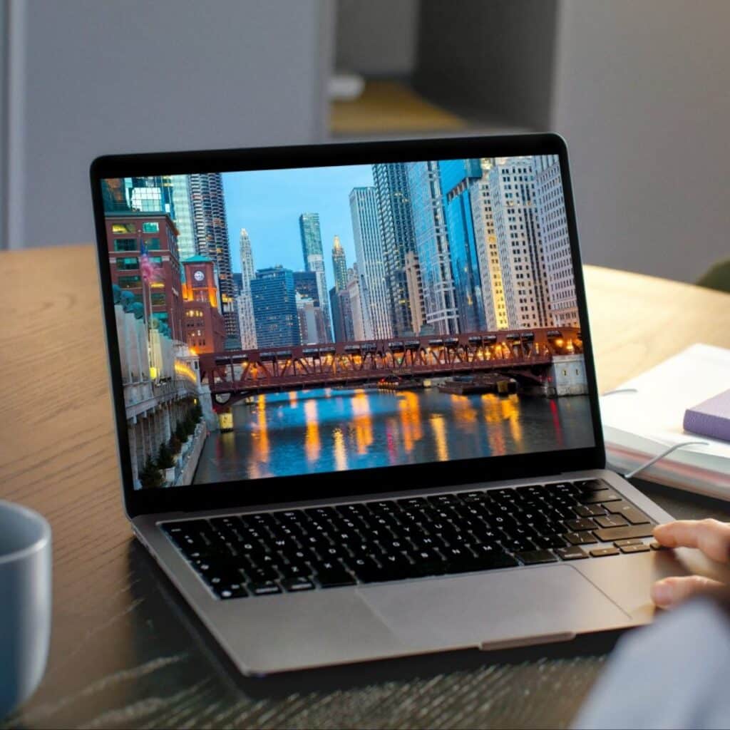 Laptop displaying Chicago skyline at dusk from chicago web design company.